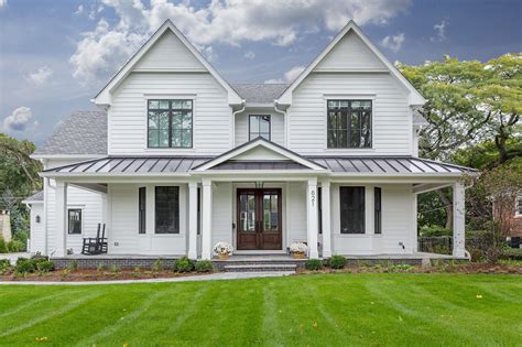 white house with burgundy metal porch roof|white house with black windows.